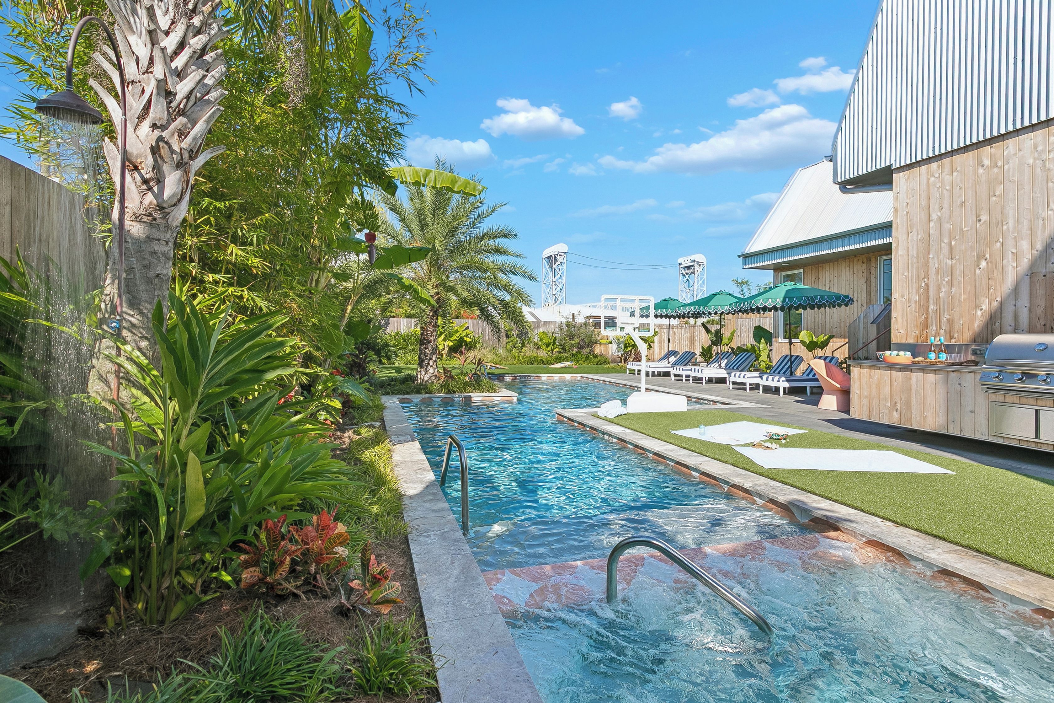 Steps into the pool, with banana plants and palms alongside.