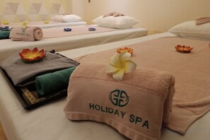 A hotel room with a bed, towels, and a bathrobe. - Holiday Pier Hotel (Mandalay)