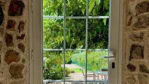 A white door with a grid of glass panes, set in a stone wall. - Pet-Friendly Holiday Home Lara with Pool and Sea view - excellent choice for a relaxing family getaway (Brzac)