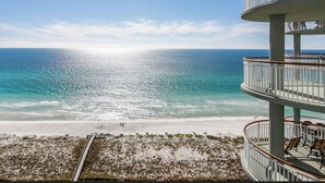 A beachfront property with a multi-level balcony overlooking the ocean.