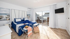A bedroom with a large bed, a TV, a balcony with a view, and a beach-themed painting. - Villa Dulce in Tias With 4 Bedrooms and 2 Bathrooms (Tías)