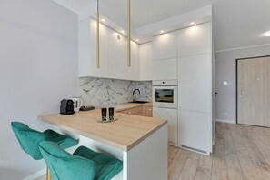 Appartement Deluxe | Coin cuisine privé | Cafetière/bouilloire, bouilloire électrique, chaise haute, épices