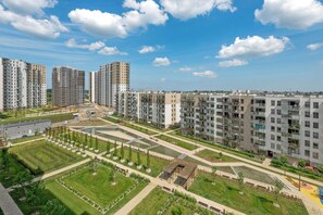 A high-rise residential building complex with multiple apartment buildings, green spaces, and a central courtyard.