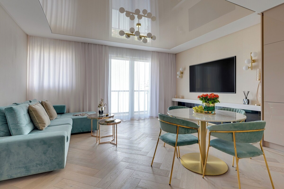 Deluxe Apartment, 1 Bedroom, Balcony | Living area | 50-inch flat-screen TV with cable channels