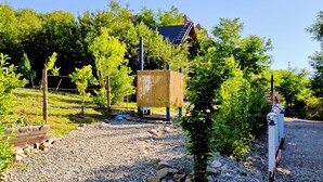 A gravel path leading to a wooden fence with a small tree in the foreground. - 479 Tiny House, Domeniul von Agodt (Bradu)