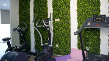 A gym with stationary bikes, elliptical machines, and treadmills.