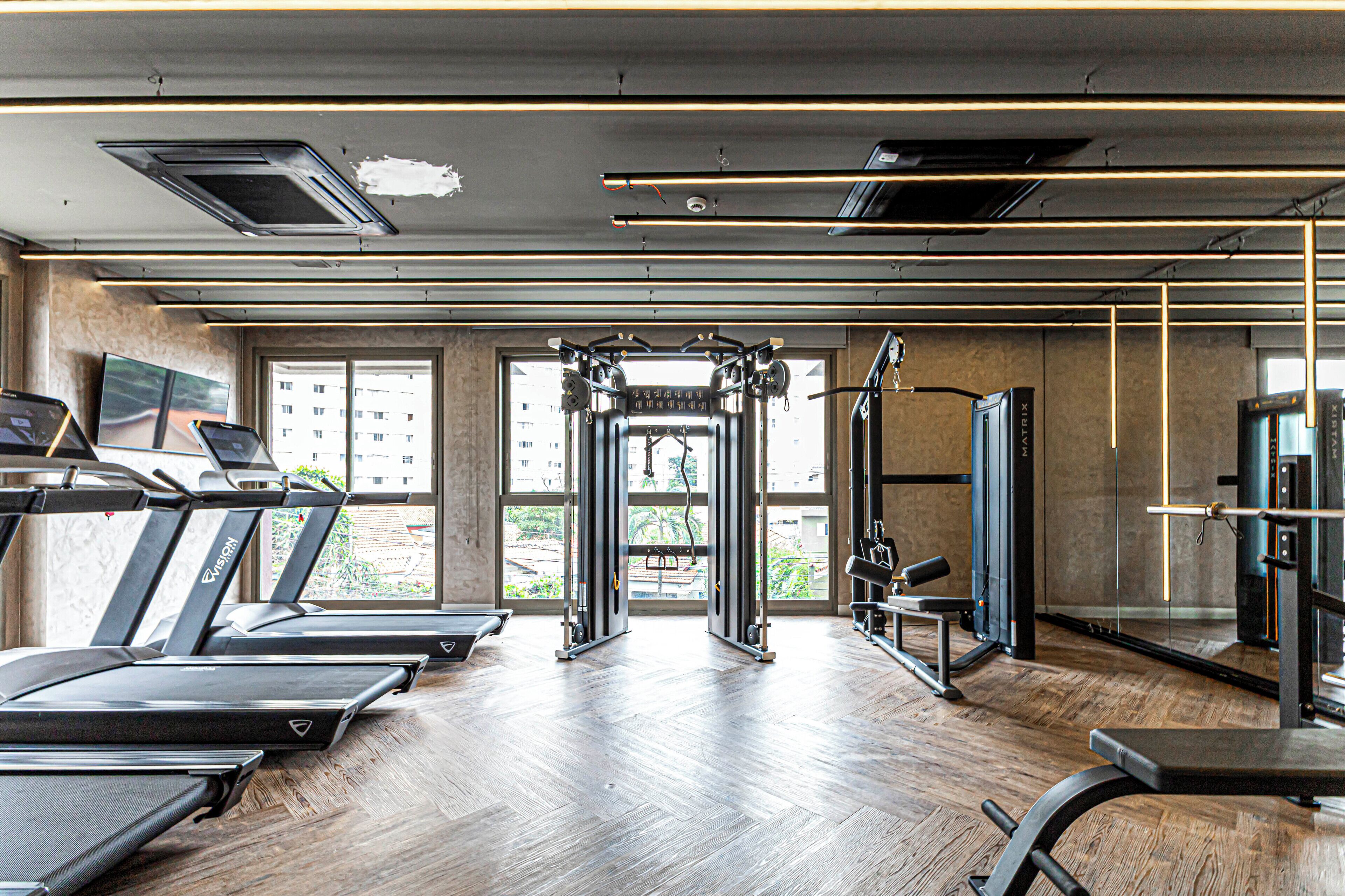 A gym with treadmills, a squat rack, and weight machines.
