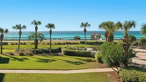 A coastal view with a pathway, palm trees, and a gazebo overlooking the sea. - Pool and Beach View from 3 Balconies (Miramar Beach)