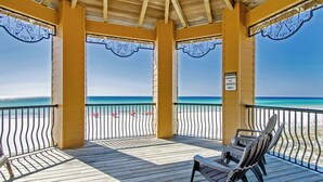 A wooden deck with a view of the ocean, a sign indicating it's for owners and guests only, and a bench. - Pool and Beach View from 3 Balconies (Miramar Beach)