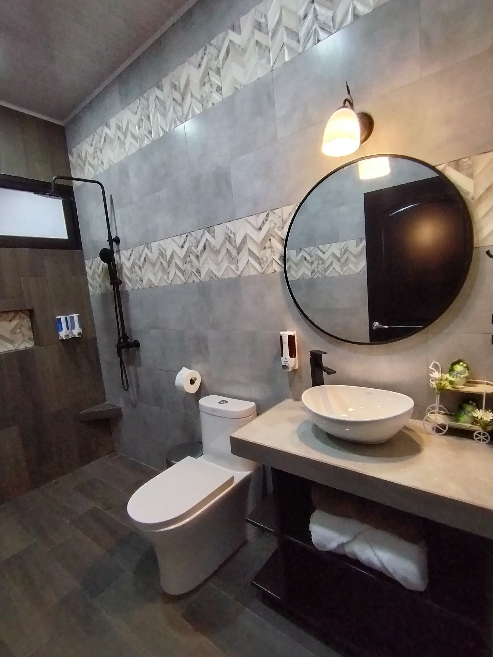 A modern bathroom with a toilet, bidet, and sink.