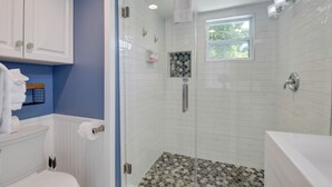 A bathroom with a shower, toilet, and sink. - Jerry's Escape - Truman @ Duval | Cozy Studio, Perfect Location! (Key West)