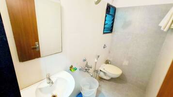 A bathroom with a sink, toilet, and shower.