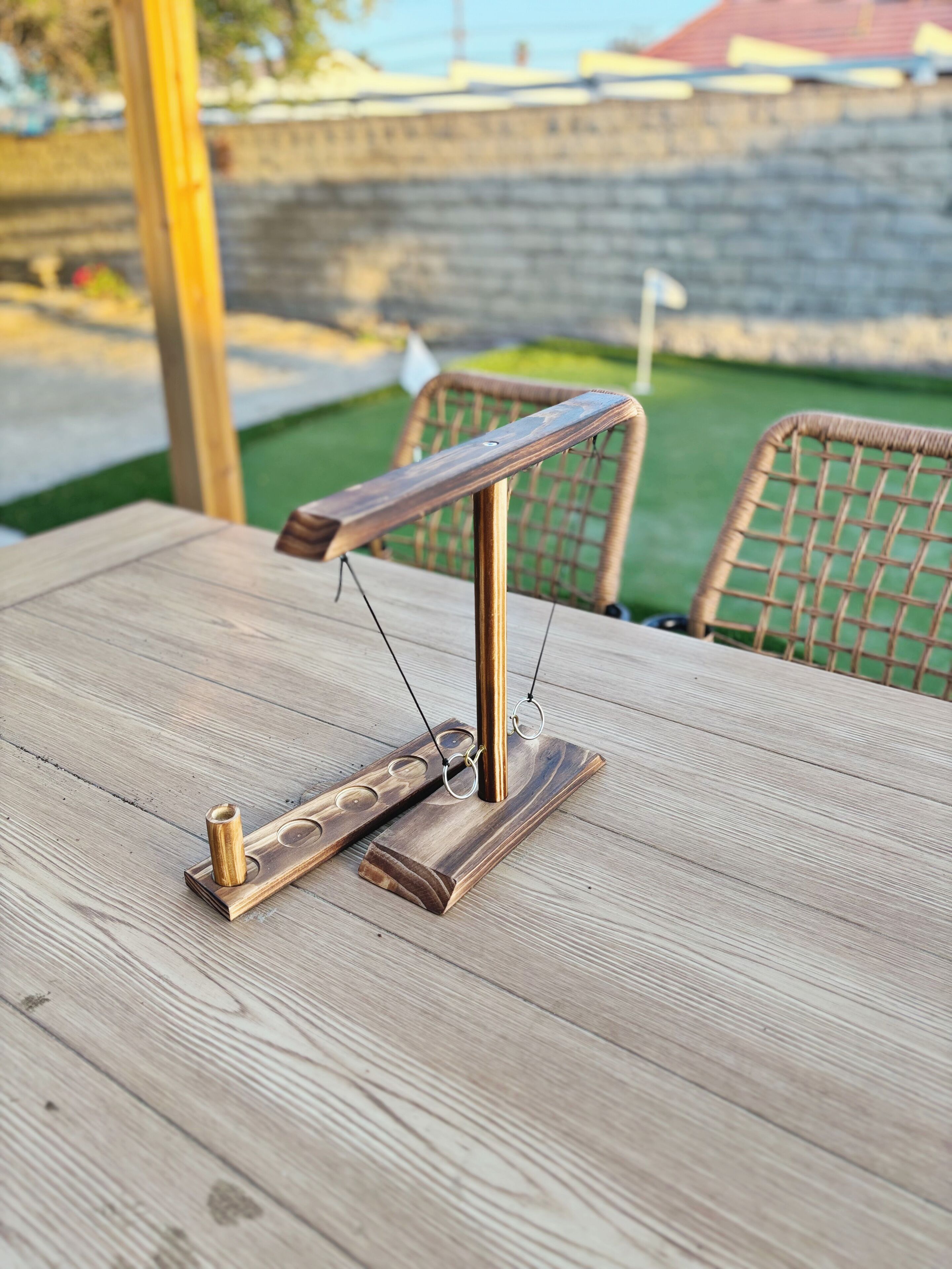 A wooden table with a metal stand and a wooden object on it.