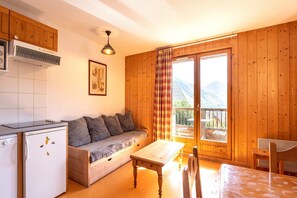 Relax in a well-appointed room with a kitchenette, sofa, and balcony offering a view.