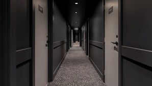 A long, narrow hallway with doors on both sides, each marked with a number.