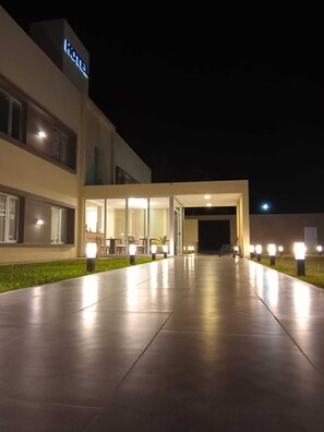 A modern hotel entrance with a well-lit pathway, large windows, and a visible 'Hotel' sign. - Achalay Colonia Dora Hotel Boutique (Colonia Dora)