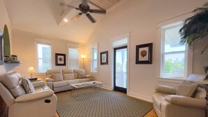 A spacious living room with a ceiling fan, a large window, and a patterned rug. - Seacrest 4BR on 30A | Walk to Dining, Shops + Beach (Inlet Beach)