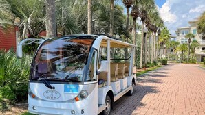 A white bus with a blue route sign labeled "Route E" parked on a brick pathway. - Labor Day Just Opened! | Seacrest Beach | Sleeps 13 (Inlet Beach)