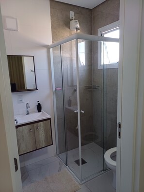 Shower, hair dryer, soap, toilet paper