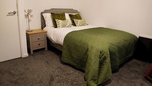 A bedroom with a bed, a nightstand, a drawer, and a door. - 1br, Balcony, Cityview, Office, Ws98 (London)