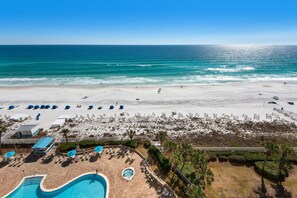 A beach resort with a swimming pool, sun loungers, and a view of the ocean. - Silver Beach Towers 1003 West (Destin)