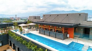 Outdoor pool, open 9:00 AM to 9:00 PM, pool umbrellas, sun loungers - Landmark Hotel (Medellín)