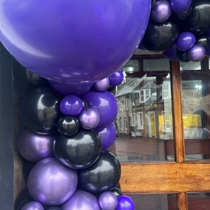 A close-up of a balloon arrangement with purple and black balloons. - Lomond Hills Hotel & Health Club  (Cupar)