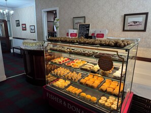 A bakery display with various pastries and a sign reading "Fisher & Donaldson." - Lomond Hills Hotel & Health Club  (Cupar)