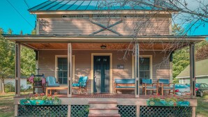 A two-story house with a porch, a front door, and a sign indicating directions to 'Savin Rock' and 'Whitewater'. - 4BR Bartlett. Near Attitash & Saco River. Sleeps 10+ (Bartlett)