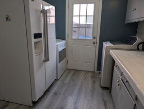 Enjoy cooking in this well-equipped kitchen with a refrigerator, oven, and microwave.