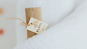 Een opgerold voorwerp met een label met de tekst 'ELSYL' op een wit, gestructureerd oppervlak.