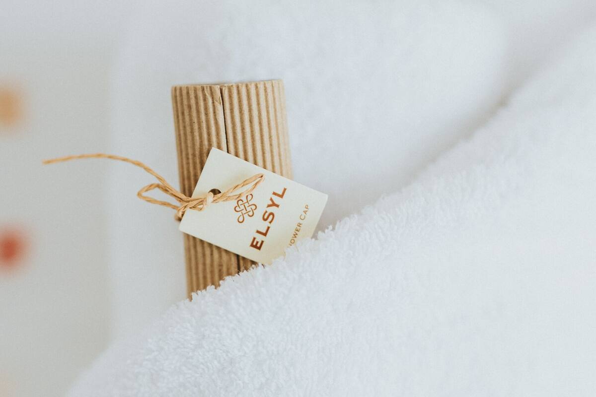 A rolled-up item with a tag labeled "ELSYL" on a white textured surface.