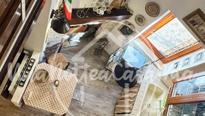A kitchen with a wooden countertop, a sink, and a window with a view of the outdoors. - La Scalinatella "UnaNotteaCasaMia" (SACROFANO)