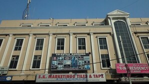 A building with a large marquee advertising 'Celestile Karishma' and 'S.K. Marketing Tiles & Taps'. - Hotel royal inn (Hyderabad)