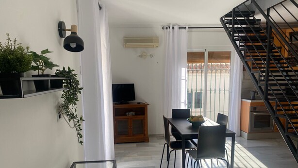 A modern kitchen with a built-in oven and a black staircase. - 1029 Casa Evelyn C (Nerja)