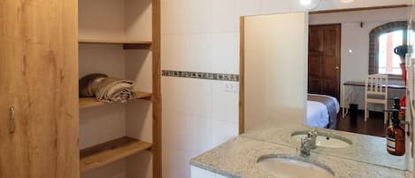 A bathroom with wooden cabinets, a sink, and a mirror.