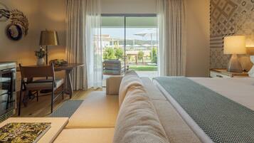 A hotel room with a bed, a desk, a chair, a lamp, and a view of the outdoors.