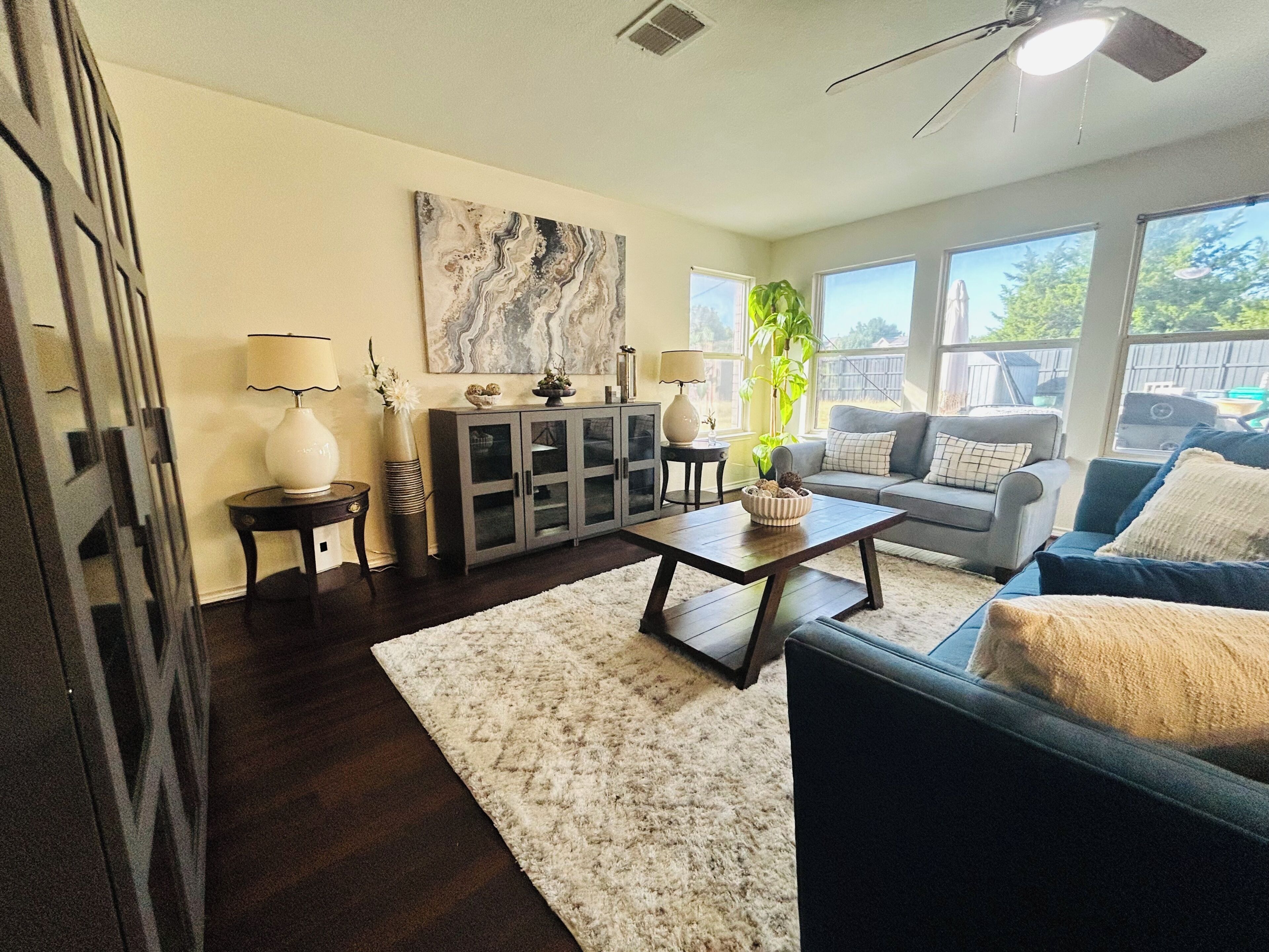 A living room with a sofa, coffee table, and cabinets.