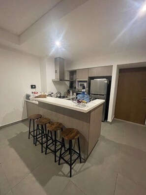 Fridge, microwave, stovetop, coffee/tea maker