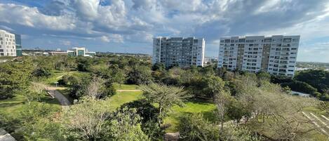 A residential area with modern apartment buildings, green spaces, and a clear sky.
