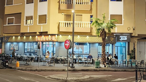 A hotel named "NAK HILDAK HOTEL" with outdoor seating and a palm tree. - Hotel nakhil dak (Dakhla)