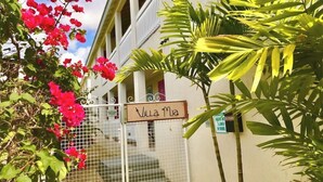A building with a sign reading "Vua Ma" and a gated entrance. - Villa Mia Apartment Studio #4 (Oistins)