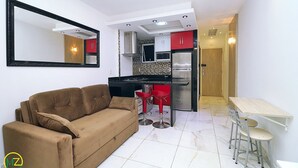 A compact living space with a kitchenette, a sofa, and a small dining area. - Prado X (Rio de Janeiro)