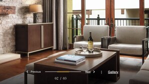 A modern living room with a fireplace, comfortable seating, and a coffee table with a book and a bottle. - Elegant 2 bedroom condo Vail. (Vail)