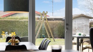 A room with a view of a wooden swing set in a backyard. - 2 bedroom awesome home in Bogense (Bogense)