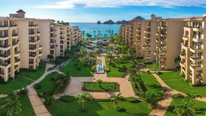 A resort with multiple-story buildings, a central pool area, and a view of the ocean. - Villa La Estancia Beach Resort & Spa Cabo San Lucas - All Inclusive (Cabo San Lucas)