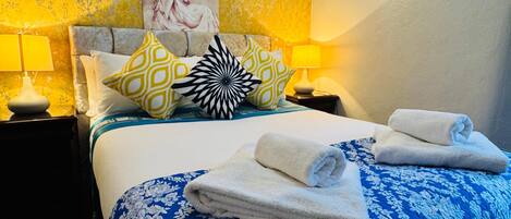 Relax in comfort with a large bed, bedside tables, and ambient lighting.