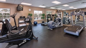 A gym with various cardio machines, including treadmills and elliptical trainers, and a wall clock. - WorldMark Branson - 1 Bedroom (Branson)