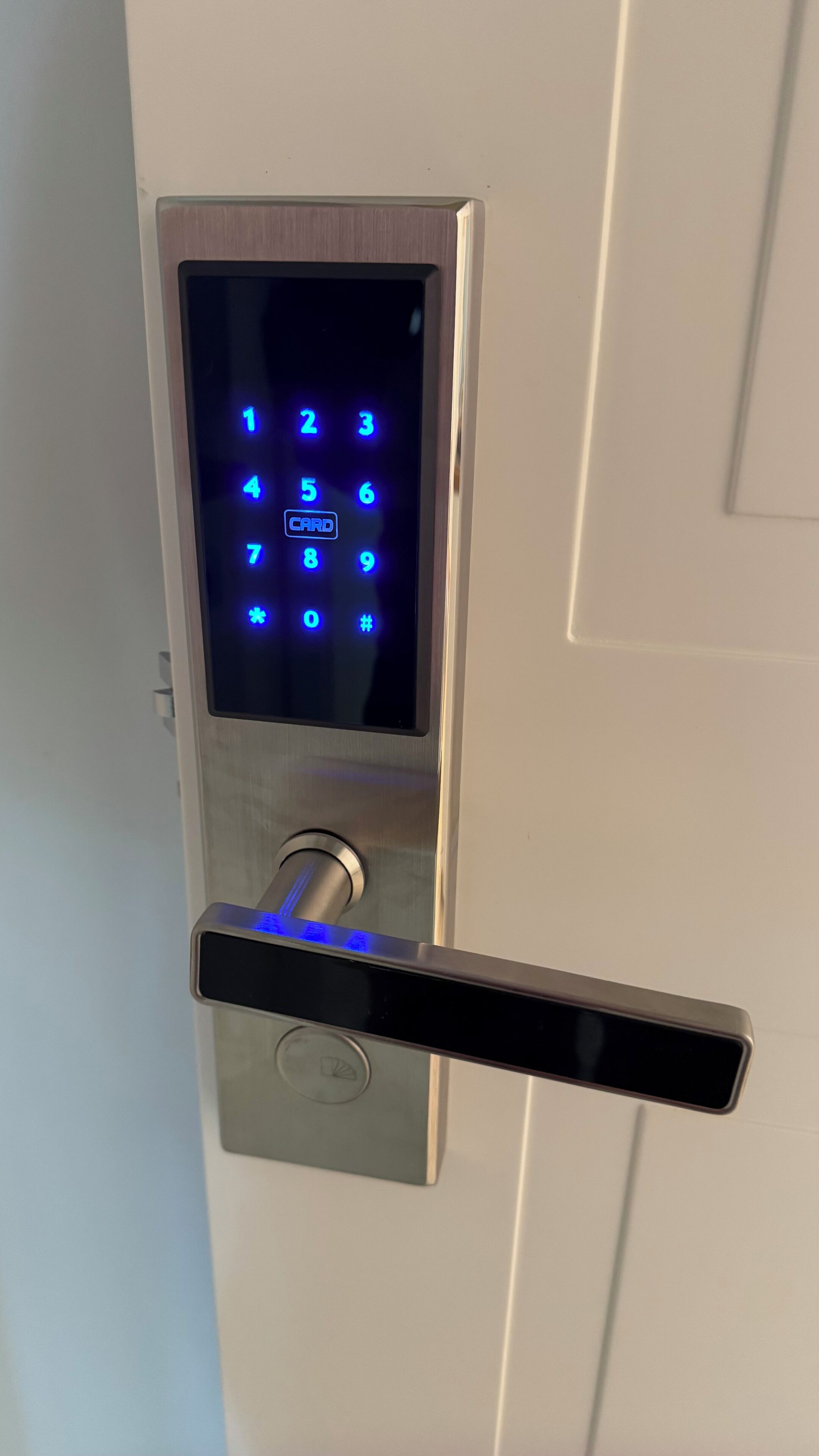 A modern door lock with a keypad and a keyhole.