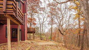 Un bâtiment rouge doté d’une terrasse en bois et d’un espace extérieur abrité.